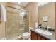Well-maintained bathroom with a glass-enclosed shower, a neutral color scheme, and a dark vanity at 1085 Harmony Ln, Clermont, FL 34711