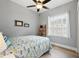 Bedroom with beachy decor, wood look floors, and a large window at 1085 Harmony Ln, Clermont, FL 34711