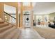 Bright foyer features soaring ceilings, tile flooring, a staircase, and views into the formal living room at 1085 Harmony Ln, Clermont, FL 34711