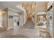 Spacious foyer with soaring ceilings, tile flooring, staircase, and views into other living spaces at 1085 Harmony Ln, Clermont, FL 34711