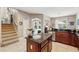 Open kitchen featuring wood cabinets, granite countertops, stainless steel appliances, and easy access to the pool at 1085 Harmony Ln, Clermont, FL 34711