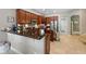 Open kitchen with stainless steel appliances, bar seating, and ample cabinetry at 1085 Harmony Ln, Clermont, FL 34711