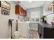 Functional laundry room with overhead cabinets, modern appliances, and a clean, organized design at 1085 Harmony Ln, Clermont, FL 34711