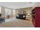 Inviting living room featuring large windows, plush carpeting, comfortable seating, and a bright ambiance at 1085 Harmony Ln, Clermont, FL 34711