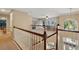 A spacious, carpeted loft area overlooking the home's entrance featuring white railings at 1085 Harmony Ln, Clermont, FL 34711
