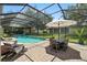 Beautiful screened-in pool area with ample seating and dining space, perfect for outdoor entertaining at 1085 Harmony Ln, Clermont, FL 34711