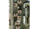 Aerial view of a condo complex featuring a pool, lake, and lush landscaping at 12527 Floridays Resort Dr # 406-E, Orlando, FL 32821