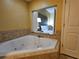 Close-up of soaking tub featuring jets and window to bedroom at 12527 Floridays Resort Dr # 406-E, Orlando, FL 32821