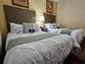 Bedroom featuring two beds with decorative pillows, carpeting, and neutral wall color at 12527 Floridays Resort Dr # 406-E, Orlando, FL 32821