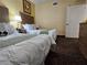 Bedroom with two beds, neutral decor, and carpeted flooring at 12527 Floridays Resort Dr # 406-E, Orlando, FL 32821