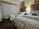 Bedroom with two beds, framed artwork, neutral decor, and carpeted flooring at 12527 Floridays Resort Dr # 406-E, Orlando, FL 32821