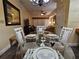 Elegant dining area featuring a glass-top table set for a meal, complemented by comfortable seating and decor at 12527 Floridays Resort Dr # 406-E, Orlando, FL 32821