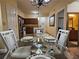 Elegant dining room with a glass table, set for four, and hardwood flooring at 12527 Floridays Resort Dr # 406-E, Orlando, FL 32821