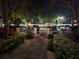 Well-lit entrance walkway at night surrounded by landscaping at 12527 Floridays Resort Dr # 406-E, Orlando, FL 32821