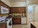 Well-equipped kitchen with white appliances, and granite countertops at 12527 Floridays Resort Dr # 406-E, Orlando, FL 32821