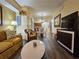 Inviting living room featuring warm tones, stylish furniture, and hardwood flooring at 12527 Floridays Resort Dr # 406-E, Orlando, FL 32821