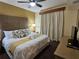 Serene main bedroom with a king-sized bed, stylish linens, and a TV for relaxing evenings at 12527 Floridays Resort Dr # 406-E, Orlando, FL 32821