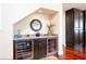 Stylish wet bar featuring wine refrigerators, custom cabinetry, granite countertop, and elegant lighting at 12765 Se 143Rd Ave, Ocklawaha, FL 32179
