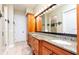 Bathroom with double vanity, granite counters, and wood cabinetry at 12765 Se 143Rd Ave, Ocklawaha, FL 32179