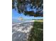 Sandy beach with a thatched-roof gazebo and chairs with an expansive view of the water at 12765 Se 143Rd Ave, Ocklawaha, FL 32179