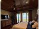This bedroom boasts water views, wood-paneled ceilings, and an ensuite bathroom at 12765 Se 143Rd Ave, Ocklawaha, FL 32179