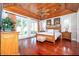 This primary bedroom boasts wood floors, wood-paneled ceilings, and an ensuite bathroom at 12765 Se 143Rd Ave, Ocklawaha, FL 32179