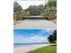 An ornate community gate at Sandy Hook and a view of the beach, water and grassy area at 12765 Se 143Rd Ave, Ocklawaha, FL 32179
