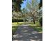 Long, private driveway leading to a lovely home with mature landscaping and beautiful trees at 12765 Se 143Rd Ave, Ocklawaha, FL 32179