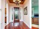 Inviting entryway with hardwood floors, a decorative chandelier, and views into adjacent rooms at 12765 Se 143Rd Ave, Ocklawaha, FL 32179