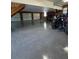 Spacious garage with three doors, epoxy flooring, wood paneled walls and an upstairs entrance at 12765 Se 143Rd Ave, Ocklawaha, FL 32179