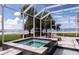 Relaxing hot tub in a screened enclosure, offering a private retreat with waterfront views at 12765 Se 143Rd Ave, Ocklawaha, FL 32179