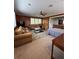 This large living area features wood paneling, a ceiling fan, and a wet bar at 12765 Se 143Rd Ave, Ocklawaha, FL 32179