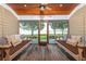 Inviting porch featuring swing benches and a lake view, creating a relaxing outdoor space at 12765 Se 143Rd Ave, Ocklawaha, FL 32179