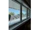 Beautiful waterfront views from the home's windows showcase the pool and the adjacent lake at 12765 Se 143Rd Ave, Ocklawaha, FL 32179