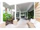 Charming walkway surrounded by tropical landscaping, leading to a welcoming entrance with a cozy bench at 12765 Se 143Rd Ave, Ocklawaha, FL 32179