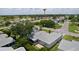 Elevated aerial view of the community featuring mature trees, lush lawns, and a nearby golf course at 1305 Guerra Ave, The Villages, FL 32159