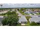 Aerial view features lush trees, lawns, and a water tower in the distance of the beautiful community at 1305 Guerra Ave, The Villages, FL 32159