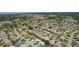 Aerial view of the neighborhood featuring lush greenery, lakes, and golf courses at 1305 Guerra Ave, The Villages, FL 32159