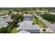 Aerial view showcases mature trees and landscaping with a golf cart parked at the end of the paved drive at 1305 Guerra Ave, The Villages, FL 32159