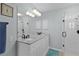 Bathroom showcases double sinks with granite countertops and a walk-in glass shower at 1305 Guerra Ave, The Villages, FL 32159