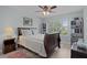 Bedroom with a wood frame bed, ceiling fan, window and shelf at 1305 Guerra Ave, The Villages, FL 32159
