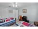 Bright bedroom with two beds, a ceiling fan, and a desk space at 1305 Guerra Ave, The Villages, FL 32159