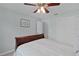 Bedroom featuring a dark wood frame bed, ceiling fan and double door closet at 1305 Guerra Ave, The Villages, FL 32159