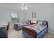 Bright bedroom with two beds, a ceiling fan, and a window at 1305 Guerra Ave, The Villages, FL 32159