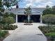 View of restrooms nestled amongst meticulously landscaped grounds featuring flowering plants and pavers at 1305 Guerra Ave, The Villages, FL 32159