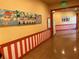 Hallway with unique artistic touches, bright walls and trim at 1305 Guerra Ave, The Villages, FL 32159