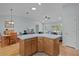 Kitchen island with wood cabinets and light blue countertops at 1305 Guerra Ave, The Villages, FL 32159