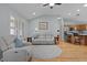 Open-concept living room with hardwood floors, large windows, and access to the kitchen at 1305 Guerra Ave, The Villages, FL 32159