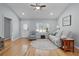 Comfortable living room featuring hardwood floors, ample seating, and plenty of natural light at 1305 Guerra Ave, The Villages, FL 32159