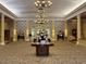 An elegant lobby showcases a large floral arrangement, chandeliers, and classic interior design elements at 1305 Guerra Ave, The Villages, FL 32159